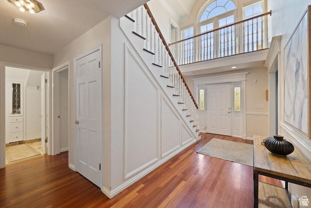 entryway featuring stairs, wood finished floors, and baseboards