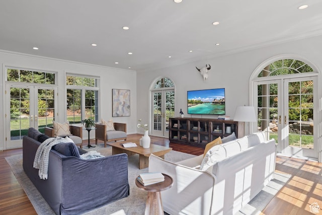 living room featuring french doors, ornamental molding, wood finished floors, and recessed lighting