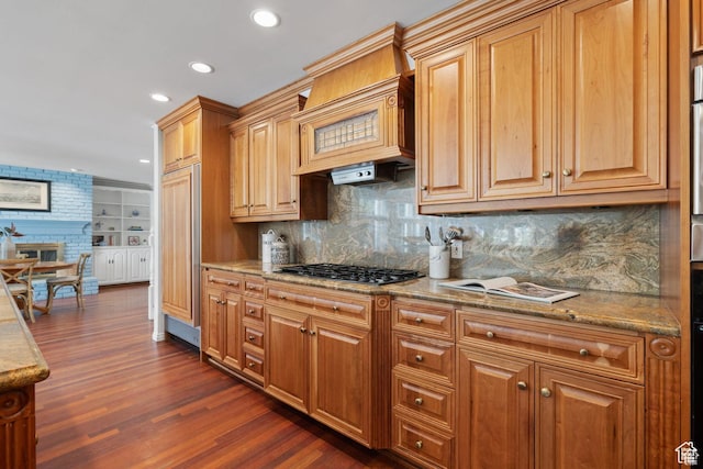 kitchen with dark wood finished floors, gas cooktop, recessed lighting, backsplash, and light stone countertops