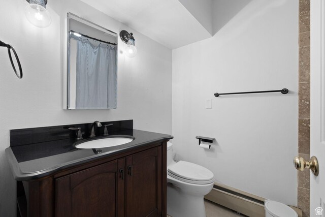 bathroom with a baseboard radiator, toilet, and vanity