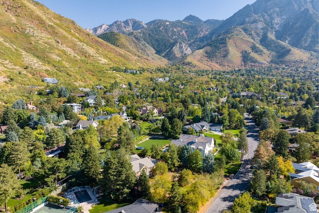 aerial view of property and surrounding area featuring mountains and nearby suburban area