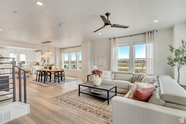 1474 W Cook Ln N Unit 163, Farmington, UT 84025 - living area with ceiling fan, light wood finished floors, a textured ceiling, and recessed lighting
