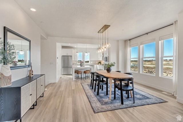 1474 W Cook Ln N Unit 163, Farmington, UT 84025 - dining room featuring light wood-type flooring, baseboards, a chandelier, and recessed lighting