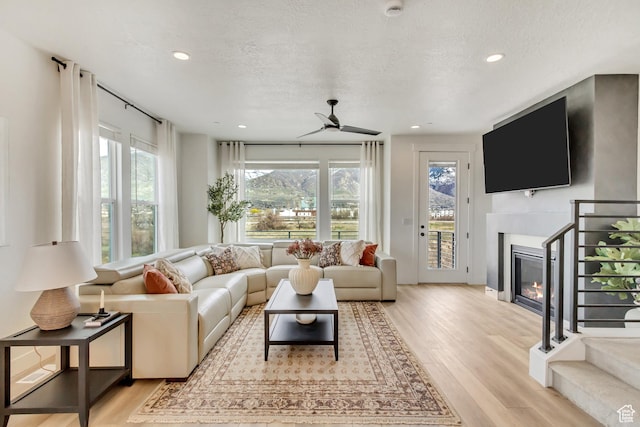 1474 W Cook Ln N Unit 163, Farmington, UT 84025 - living room featuring healthy amount of natural light, light wood-style floors, ceiling fan, recessed lighting, and a textured ceiling