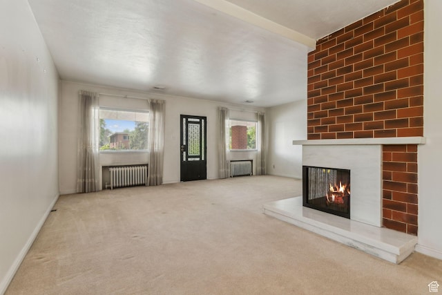 1435 S 500 E, Salt Lake City, UT 84105 - unfurnished living room with radiator heating unit, a multi sided fireplace, carpet, and baseboards
