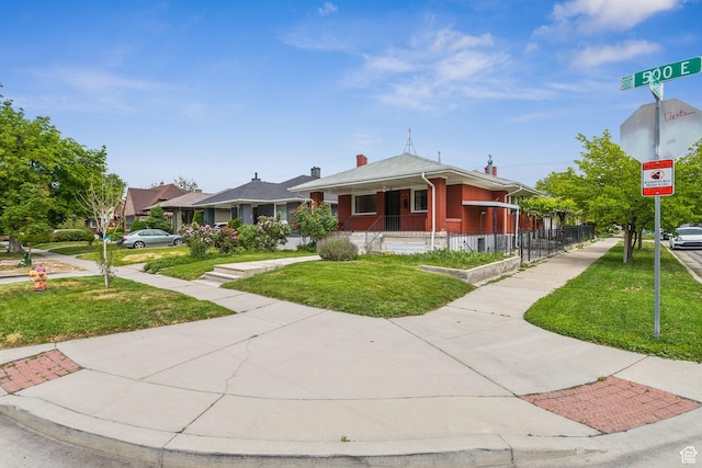 1435 S 500 E, Salt Lake City, UT 84105 - bungalow-style home with a front lawn, brick siding, and a chimney