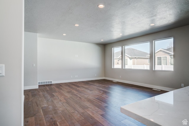 1269 W Hendrix St Unit 146, Riverton, UT 84065 - unfurnished room with a textured ceiling, wood-type flooring, baseboards, and recessed lighting