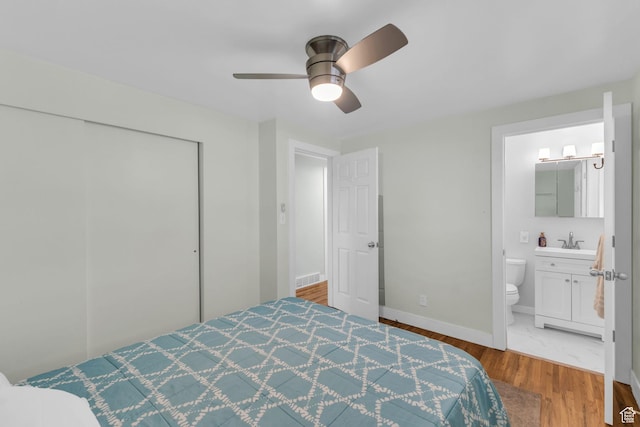 492 W Highland Dr, Riverdale, UT 84405 - bedroom featuring a sink, wood finished floors, a closet, baseboards, and a ceiling fan