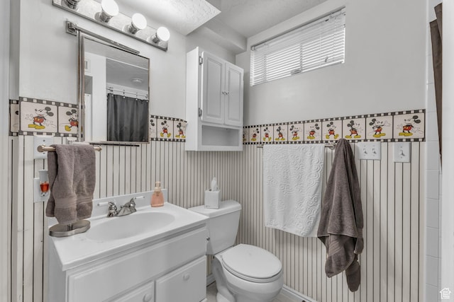 492 W Highland Dr, Riverdale, UT 84405 - bathroom with a wainscoted wall, toilet, and vanity