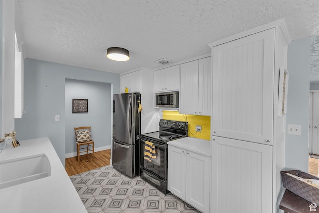 492 W Highland Dr, Riverdale, UT 84405 - kitchen featuring appliances with stainless steel finishes, light countertops, white cabinets, baseboards, and backsplash