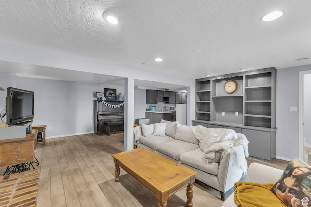 492 W Highland Dr, Riverdale, UT 84405 - living area with a textured ceiling, baseboards, recessed lighting, and light wood-style flooring