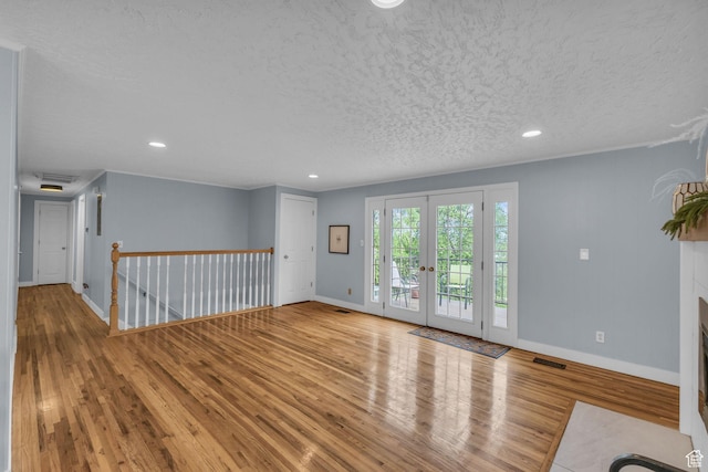 492 W Highland Dr, Riverdale, UT 84405 - spare room with wood finished floors, baseboards, a textured ceiling, recessed lighting, and french doors