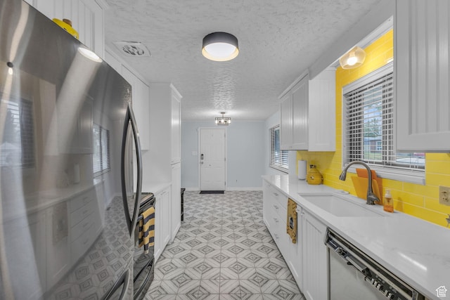 492 W Highland Dr, Riverdale, UT 84405 - kitchen featuring freestanding refrigerator, dishwasher, a sink, white cabinets, and a textured ceiling
