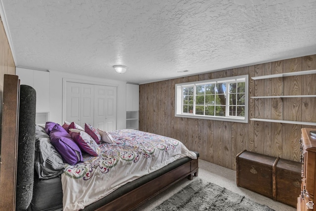 492 W Highland Dr, Riverdale, UT 84405 - bedroom featuring wooden walls, a closet, a textured ceiling, and carpet floors
