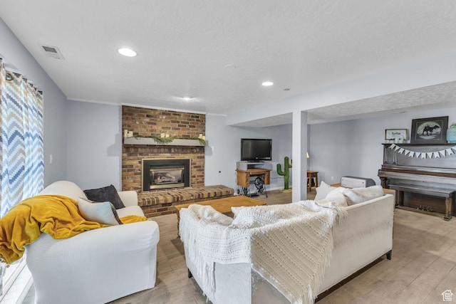 492 W Highland Dr, Riverdale, UT 84405 - living area with a brick fireplace, a textured ceiling, light wood-style flooring, and recessed lighting