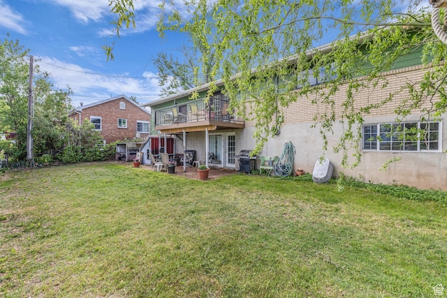 492 W Highland Dr, Riverdale, UT 84405 - back of property with a lawn, stucco siding, and a deck