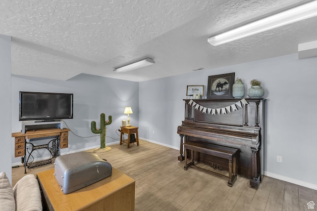 492 W Highland Dr, Riverdale, UT 84405 - living area with a textured ceiling, wood finished floors, and baseboards