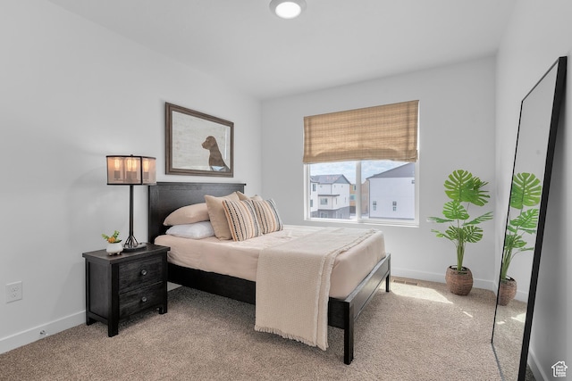 carpeted bedroom with baseboards