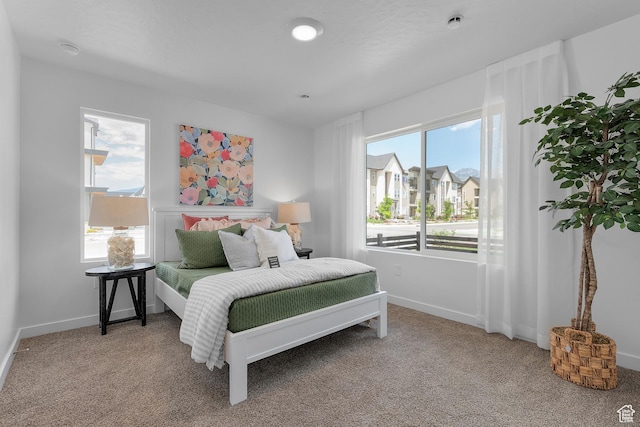 carpeted bedroom featuring baseboards