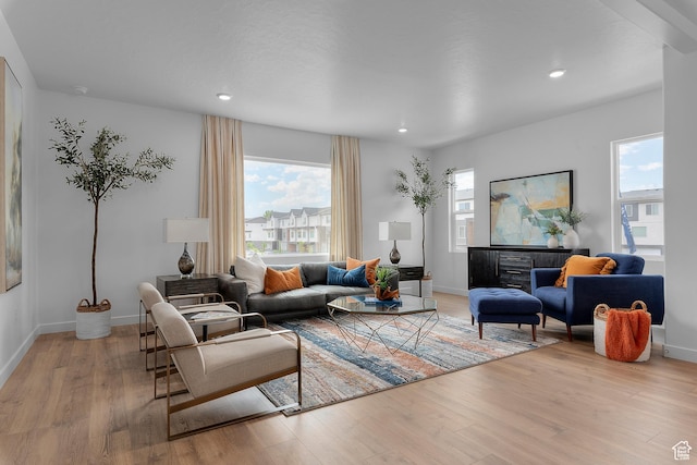 living area with light wood-style flooring, recessed lighting, and baseboards