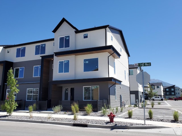 view of front of house featuring stucco siding and a residential view