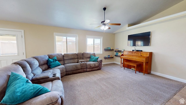 living room with ceiling fan, lofted ceiling, and baseboards