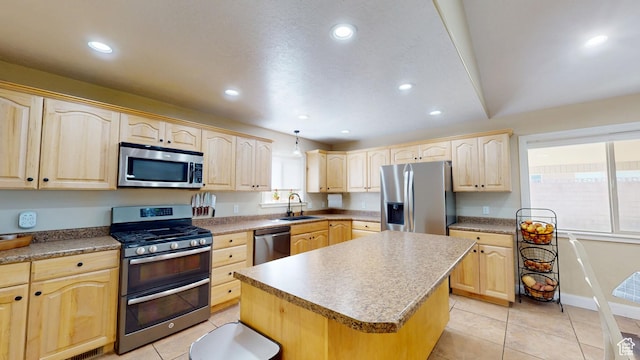 kitchen featuring stainless steel appliances, light brown cabinets, and recessed lighting