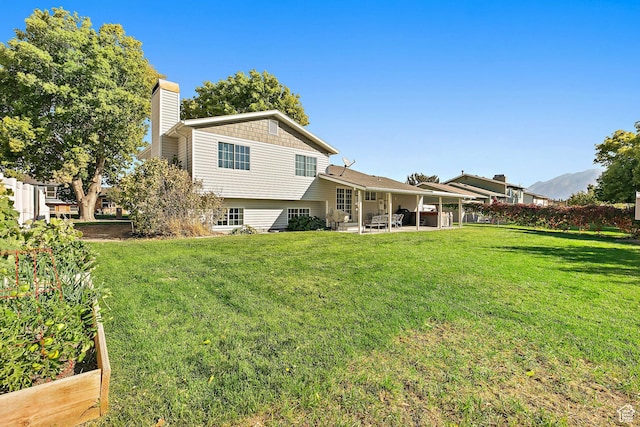 2119 W 12190 S, Riverton, UT 84065 - back of property featuring a chimney, a patio, and a yard