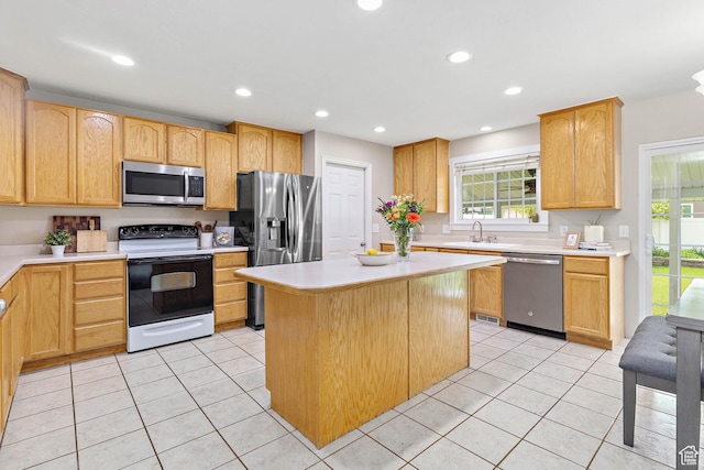 2119 W 12190 S, Riverton, UT 84065 - kitchen featuring stainless steel appliances, light countertops, a sink, a center island, and light tile patterned floors