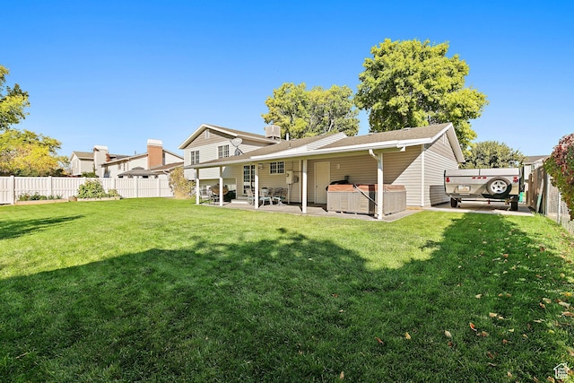 2119 W 12190 S, Riverton, UT 84065 - back of house with a hot tub and a patio area