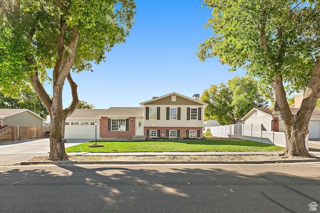 2119 W 12190 S, Riverton, UT 84065 - split level home with brick siding, a garage, driveway, and a chimney