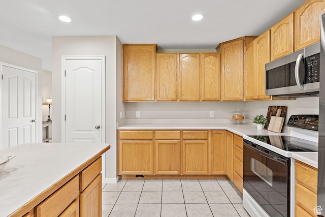 2119 W 12190 S, Riverton, UT 84065 - kitchen featuring electric range, stainless steel microwave, light countertops, light tile patterned floors, and light brown cabinets