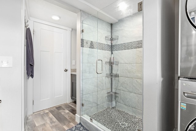 2119 W 12190 S, Riverton, UT 84065 - bathroom with a stall shower, stacked washer / dryer, and wood finished floors