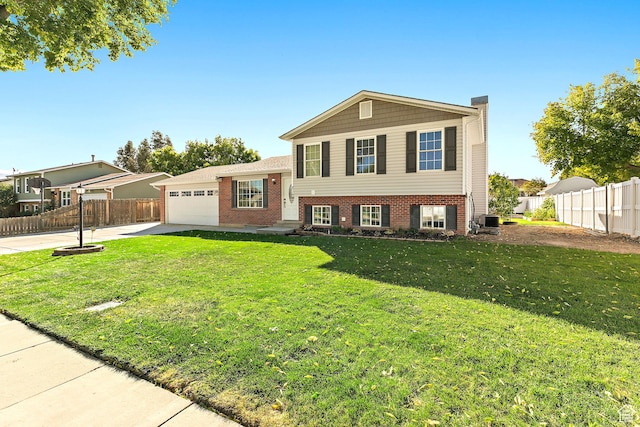 2119 W 12190 S, Riverton, UT 84065 - tri-level home with a garage, brick siding, concrete driveway, and cooling unit