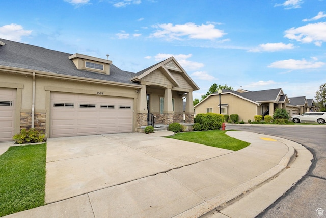 craftsman-style home with stone siding, driveway, a porch, and stucco siding