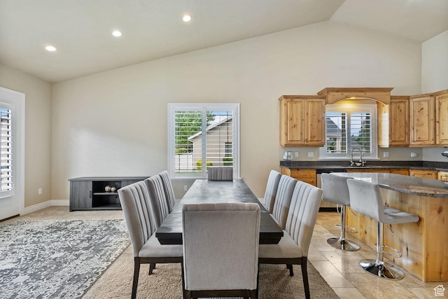 dining space featuring plenty of natural light, lofted ceiling, and recessed lighting