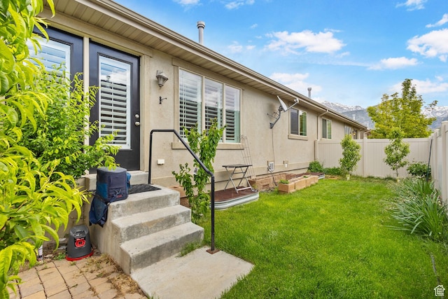 entrance to property featuring stucco siding