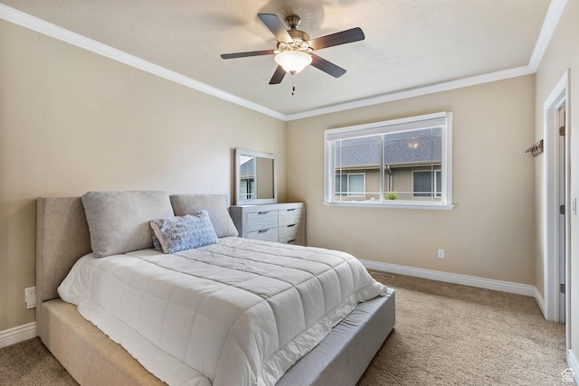 bedroom featuring carpet, baseboards, ornamental molding, and ceiling fan