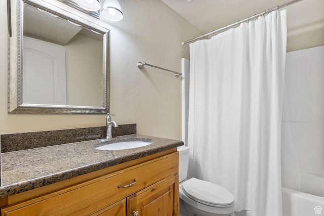 bathroom with toilet, vanity, and shower / bath combo with shower curtain