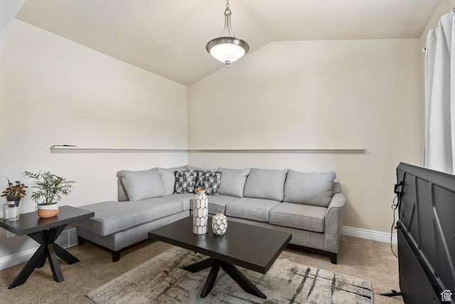 living area with lofted ceiling, light colored carpet, and baseboards