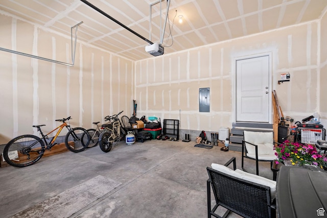 garage featuring electric panel and a garage door opener
