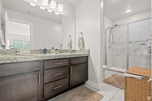 bathroom featuring a shower stall, marble finish floors, toilet, baseboards, and vanity