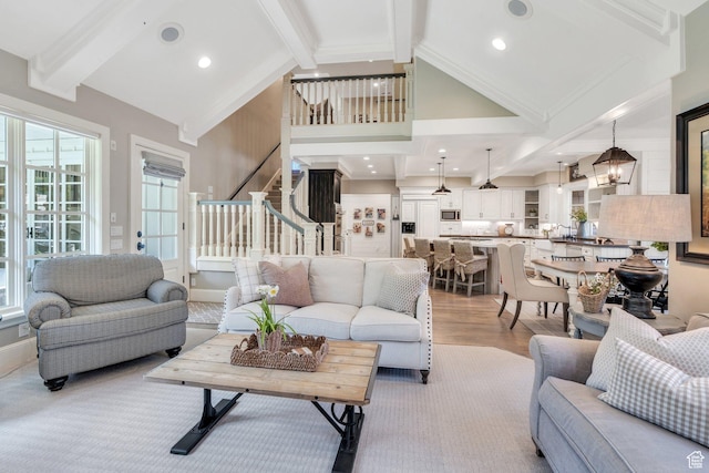 575 S 1560 E, Mapleton, UT 84664 - living area with beamed ceiling, stairs, wood finished floors, high vaulted ceiling, and a chandelier