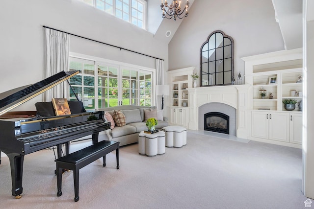 575 S 1560 E, Mapleton, UT 84664 - living area featuring a towering ceiling, a chandelier, carpet flooring, plenty of natural light, and a fireplace with raised hearth