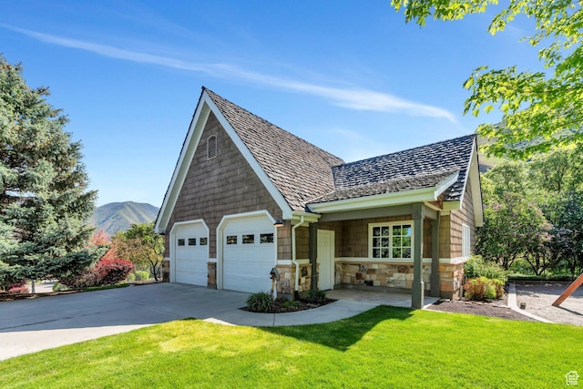 575 S 1560 E, Mapleton, UT 84664 - view of front facade with stone siding, a front lawn, concrete driveway, and a mountain view