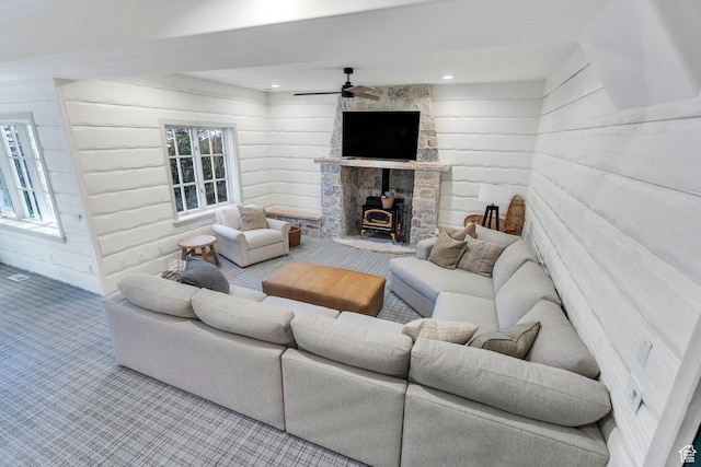 575 S 1560 E, Mapleton, UT 84664 - carpeted living room featuring a wood stove, wood walls, and a ceiling fan