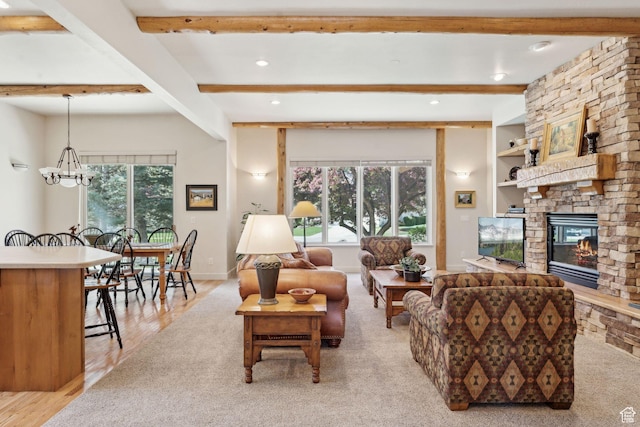 living room featuring a stone fireplace, beamed ceiling, healthy amount of natural light, a chandelier, and recessed lighting