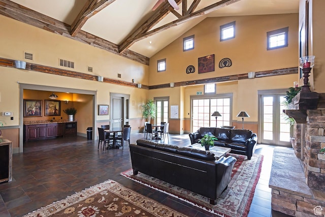 living room with high vaulted ceiling, beamed ceiling, and plenty of natural light