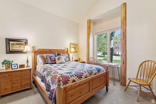bedroom featuring light carpet and vaulted ceiling