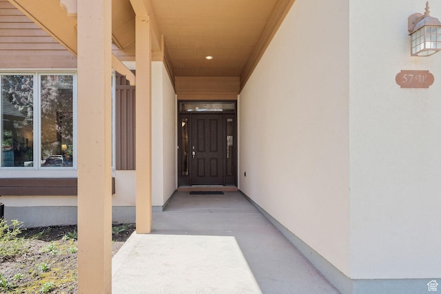 entrance to property featuring stucco siding